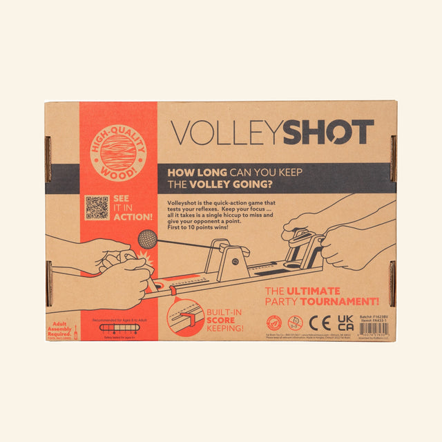 Fat Brain Toys VolleyShot Game retail box front showing the wooden tabletop game illustration, two-player paddle controls, attached ball action, and “How long can you keep the volley going?” text.
