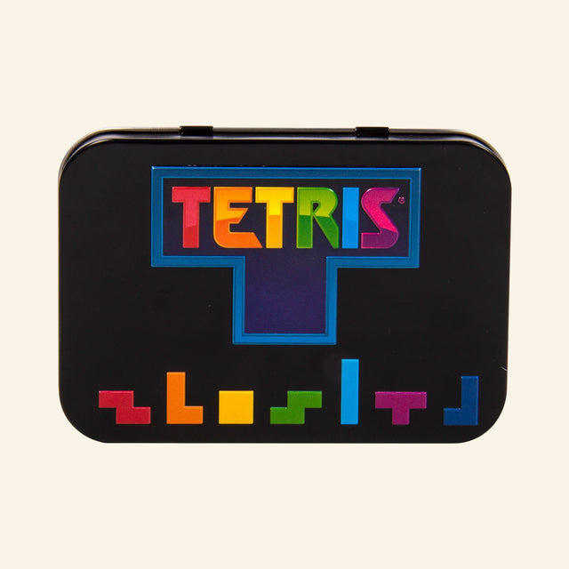 Fizz Creations Tetris Arcade in a Tin shown closed, featuring a black tin case with the colorful Tetris logo and multicolor Tetrimino block artwork along the bottom.