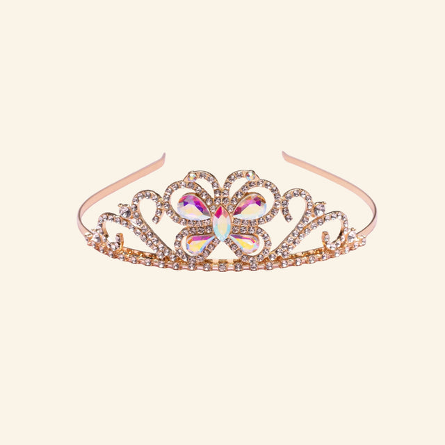 Great Pretenders Boutique Butterfly Jewel Tiara shown in rose gold with sparkling rhinestone details, heart-shaped scrollwork, and a jeweled butterfly centerpiece.