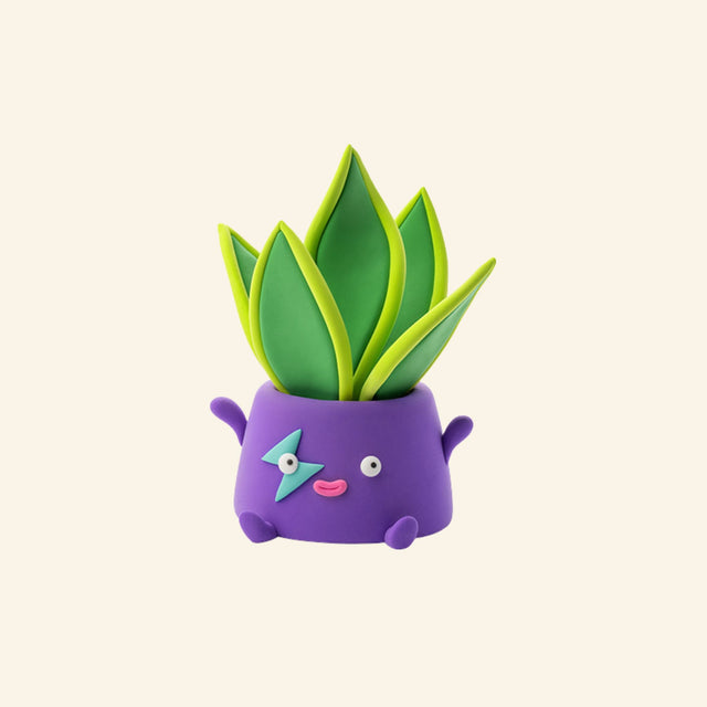 Hey Clay snake plant character sculpture in a purple smiling flower pot with bright green leaves.