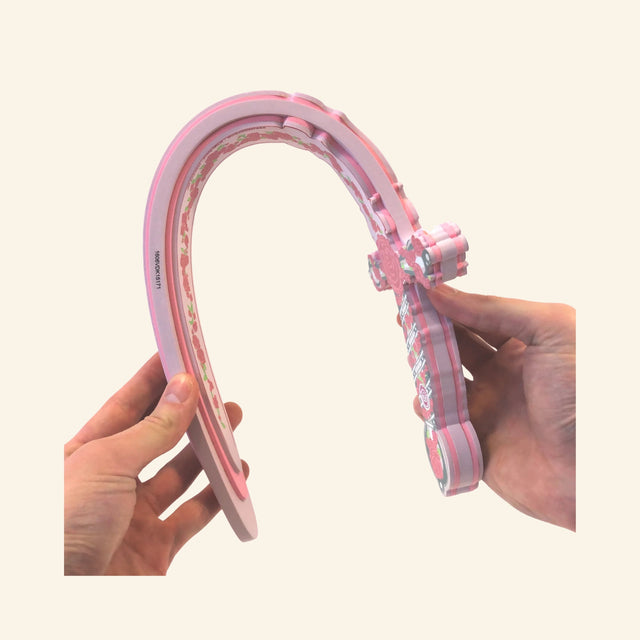 The Liontouch Rose Mary Sword being bent by hand to show the lightweight, flexible EVA foam construction.