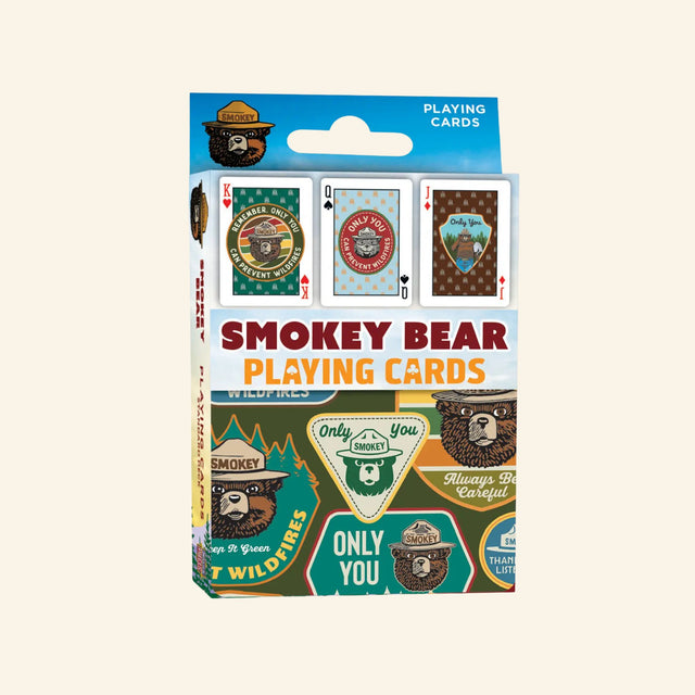 Front of MasterPieces Smokey Bear playing cards featuring official Smokey Bear artwork, wildfire prevention graphics, and a standard 52-card deck.