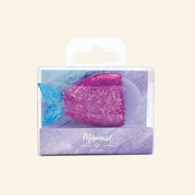 Mermaid Glitter 3D Eraser shown in a small clear peggable box, with a lavender eraser tucked inside a pink glitter mermaid tail holder and a blue glitter tail fin.