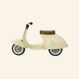 Side view of the AMBOSSTOYS PRIMO cream ride-on toy with a brown seat.
