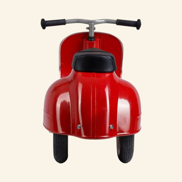 Rear view of the AMBOSSTOYS PRIMO ride-on toy scooter in red with a black seat.