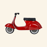 Side view of the AMBOSSTOYS PRIMO ride-on toy scooter in red with a black seat.