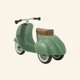 Angled front view of the AMBOSSTOYS PRIMO sage green ride-on toy with a brown seat.