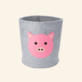 Gray felt storage bin with a layered pink pig face, designed to organize toys, books, blankets, and nursery essentials.