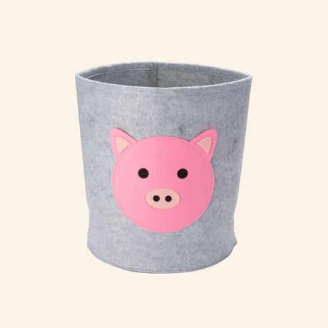 Gray felt storage bin with a layered pink pig face, designed to organize toys, books, blankets, and nursery essentials.