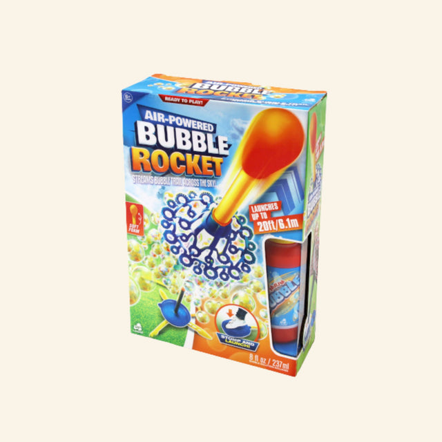 Bubble Rocket retail box showing an air-powered stomp launcher, orange-and-yellow foam-tipped rocket, blue bubble wand ring, bubble solution bottle, and graphics of bubbles streaming behind the rocket as it launches.
