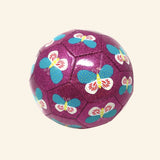 Crocodile Creek size 3 glitter soccer ball with a sparkly purple surface, stitched soccer ball panels, and repeating blue, white, yellow, and red butterfly illustrations.