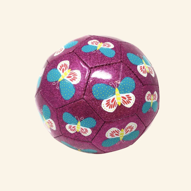 Crocodile Creek size 3 glitter soccer ball with a sparkly purple surface, stitched soccer ball panels, and repeating blue, white, yellow, and red butterfly illustrations.