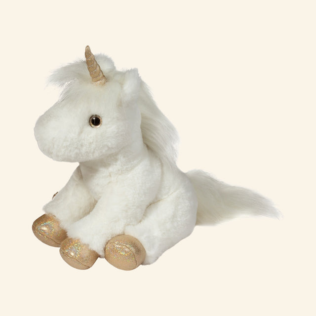 Douglas Toys Elodie White Unicorn Soft Plush shown seated at an angle with soft white fur, gold horn, long mane, fluffy tail, and shimmery golden hooves.