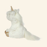 Douglas Toys Elodie White Unicorn Soft Plush shown from the back and side, featuring the soft white body, long flowing tail, fluffy mane, and gold hooves.