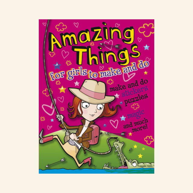 Front cover of Dover Amazing Things for Girls to Make and Do activity book showing a cartoon girl in an explorer hat holding a bow near a crocodile, with text highlighting stickers, puzzles, magic, and creative activities.