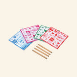 eeBoo Travel Bingo Game Set contents showing four bingo pads in blue, pink, green, and red with four small wooden pencils arranged beside them.