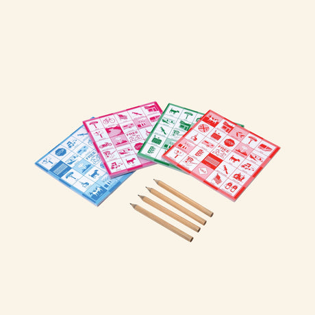 eeBoo Travel Bingo Game Set contents showing four bingo pads in blue, pink, green, and red with four small wooden pencils arranged beside them.
