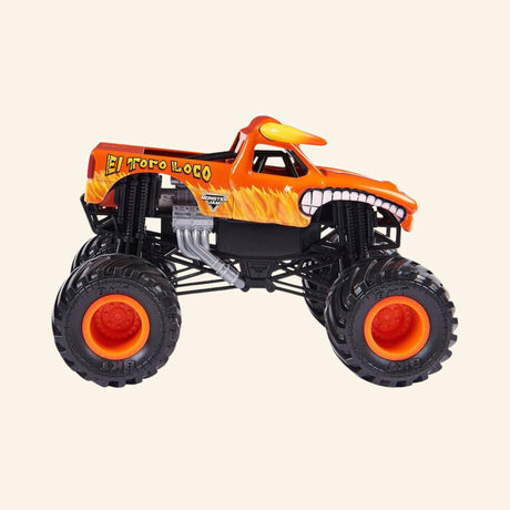Monster Jam El Toro Loco Rev ’N Roar monster truck shown from the side, featuring an orange bull-themed body with flame graphics, horns, oversized black BKT tires, orange wheel hubs, and exposed suspension.