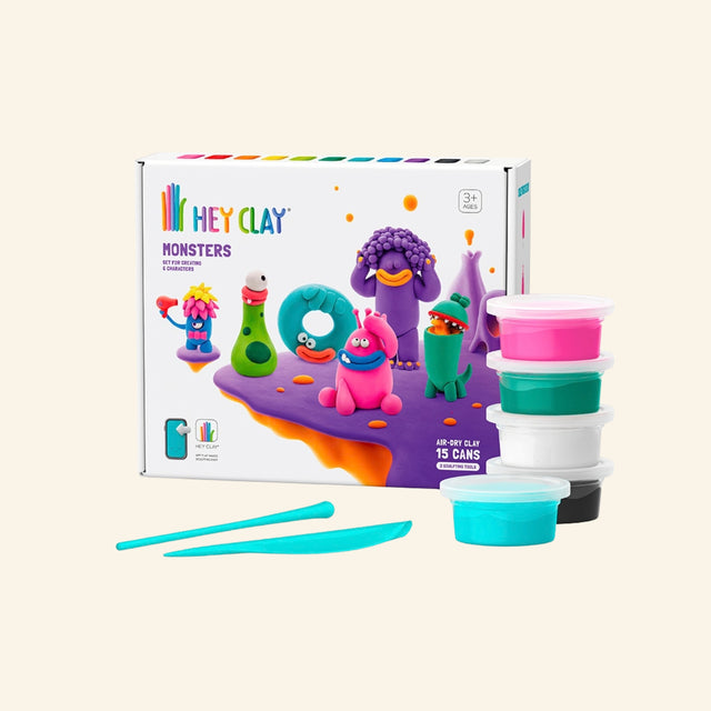 Fat Brain Toys Hey Clay – Monsters set shown with retail box, stacked colorful clay containers, sculpting tools, and finished monster character examples.