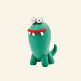 Fat Brain Toys Hey Clay – Monsters green monster character shown with tall oval body, big eyes, red mouth, white teeth, small arms, and little feet.