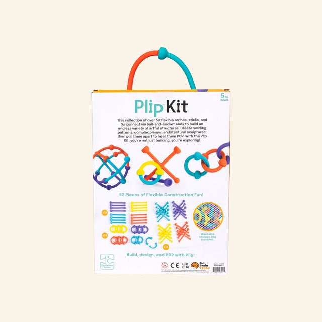 Back of the Fat Brain Toys Plip Kit box showing product description, included piece shapes, colorful construction examples, drawstring storage bag, and package details.