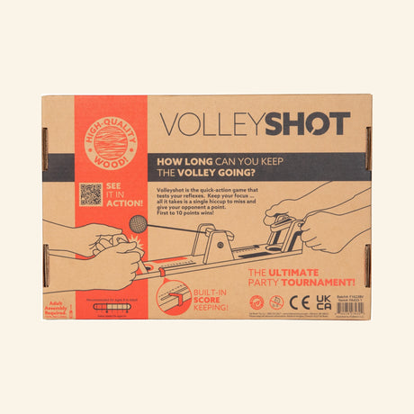 Fat Brain Toys VolleyShot Game retail box front showing the wooden tabletop game illustration, two-player paddle controls, attached ball action, and “How long can you keep the volley going?” text.