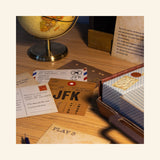 Fizz Creations Solve the Case gameplay scene showing puzzle cards, notes, clues, and case materials spread across a desk with a globe and mystery props nearby.