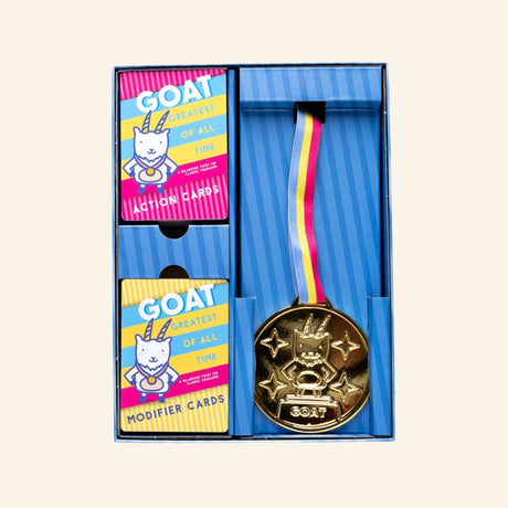 GOAT: Greatest of All Time card game contents including action cards, modifier cards, and a wearable GOAT champion medal.