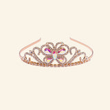 Great Pretenders Boutique Butterfly Jewel Tiara shown in rose gold with sparkling rhinestone details, heart-shaped scrollwork, and a jeweled butterfly centerpiece.