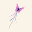 Great Pretenders Float Like a Butterfly Wand shown with a pink and purple watercolor butterfly topper, slim wand handle, and flowing ribbon tassels.