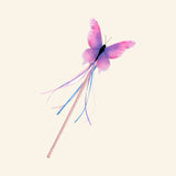 Great Pretenders Float Like a Butterfly Wand shown with a pink and purple watercolor butterfly topper, slim wand handle, and flowing ribbon tassels.