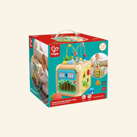 Hape Green Thumbs Activity Cube shown in retail packaging with a colorful wooden garden-themed activity cube, bead maze top, side activity panels, Hape branding, and age 1–3 guidance.