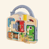 Hape Lock & Learn Playboard shown out of the box with a wooden carry handle, colorful doors, key lock, chain latch, bolt, buckle, hook lock, analog clock, light switch, and wooden cat hiding behind a door.