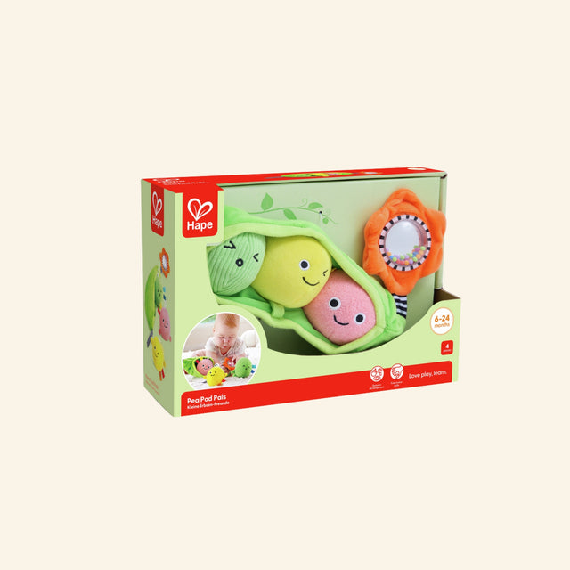 Hape Pea Pod Pals shown in angled retail packaging with the soft green pea pod, three removable plush peas, rattling flower, Hape branding, and baby sensory play details.