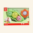 Hape Pea Pod Pals shown in front-facing retail packaging with a green plush pea pod, three smiling plush peas, orange rattling flower, baby play photo, and age 6–24 months guidance.