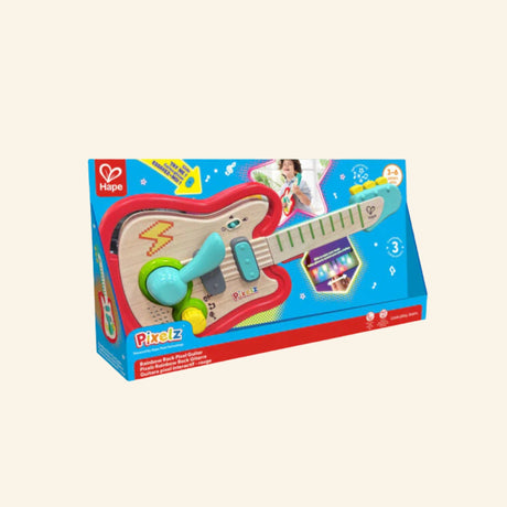 Hape Rainbow Rock Guitar shown in retail packaging with a colorful toy guitar, turquoise microphone-style piece, pixel light callout, musical graphics, and age 3–6 guidance.