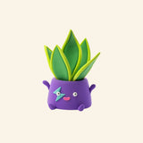 Hey Clay snake plant character sculpture in a purple smiling flower pot with bright green leaves.