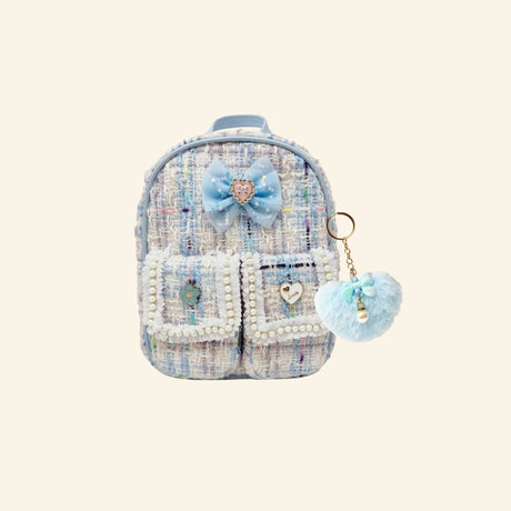 Hot Focus Stylish Beauty Mini Backpack – Flower Dream shown from the front with blue-and-white tweed-inspired fabric, pearl-trimmed front pockets, light blue bow charm, pastel trim, and fluffy blue heart keychain.