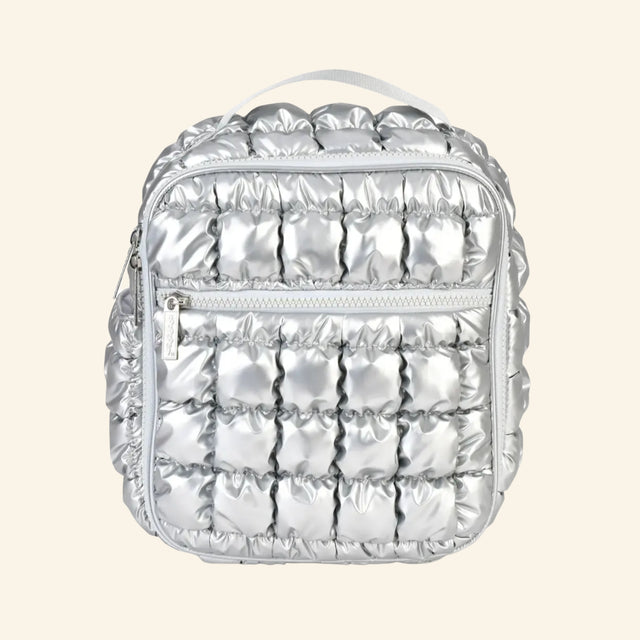 iScream Icy Silver Puffer Lunch Tote shown from the front, featuring shiny metallic silver quilted nylon, a top handle, zippered front pocket, and square insulated lunch bag shape.