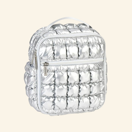 iScream Icy Silver Puffer Lunch Tote shown from an angled side view, highlighting the metallic quilted puffer texture, front zipper pocket, side pocket, top handle, and rounded zipper top.