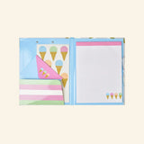 iScream Sweet Scoops Holographic Clipboard Set opened to show the interior pocket, ice cream cone sticker sheet and blue envelope with pink flap decorated with small pastel ice cream cones, and lined notepad on the right side.