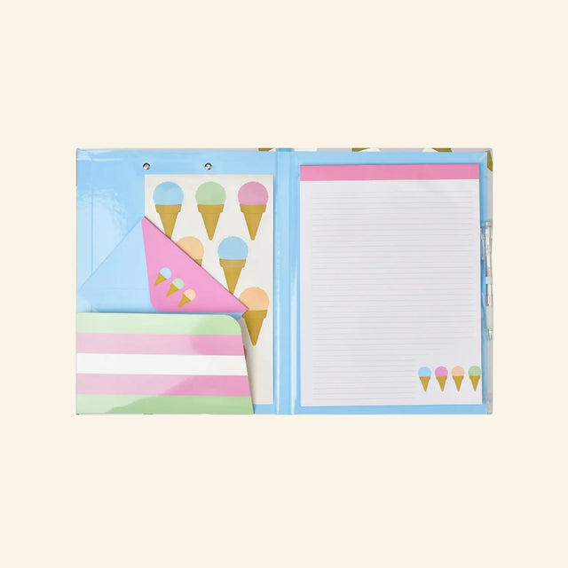 iScream Sweet Scoops Holographic Clipboard Set opened to show the interior pocket, ice cream cone sticker sheet and blue envelope with pink flap decorated with small pastel ice cream cones, and lined notepad on the right side.