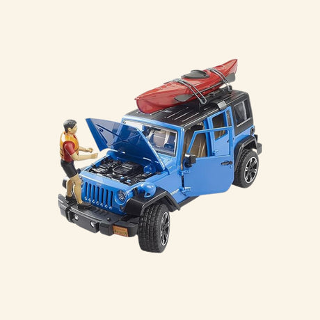 Blue Bruder Jeep Wrangler Rubicon with hood open, red kayak mounted on the roof, and kayaker figure positioned at the engine compartment.