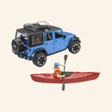 Blue Bruder Jeep Wrangler Rubicon shown from the rear with red kayak, paddle, and seated kayaker figure displayed beside it.