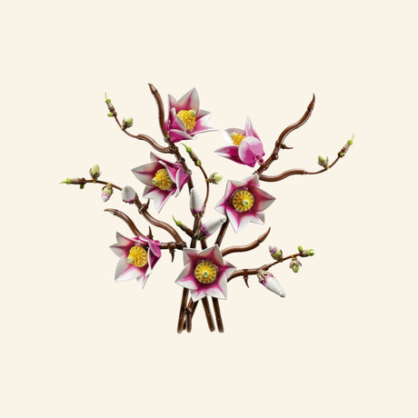 Completed LEGO Botanicals Magnolia Branches arrangement featuring five twisting brown branches with open pink-and-white magnolia flowers, green buds, and partially opened blossoms.