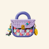 LEGO® Creator Create Art Fashion Bag shown from the front with lavender handle, pastel tile pattern, gold-style lock detail, and small hanging charms.