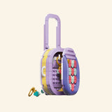 LEGO® Creator Create Art Fashion Bag shown from the side with tall lavender handle, yellow side panel, purple base, and small hanging charm accessories.
