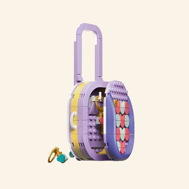 LEGO® Creator Create Art Fashion Bag shown from the side with tall lavender handle, yellow side panel, purple base, and small hanging charm accessories.