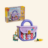 LEGO® Creator 3 in 1 Create Art Fashion Bag with Storage shown with retail box, completed lavender mini fashion bag, colorful tile decorations, gold-style charm details, and keychain accessories.