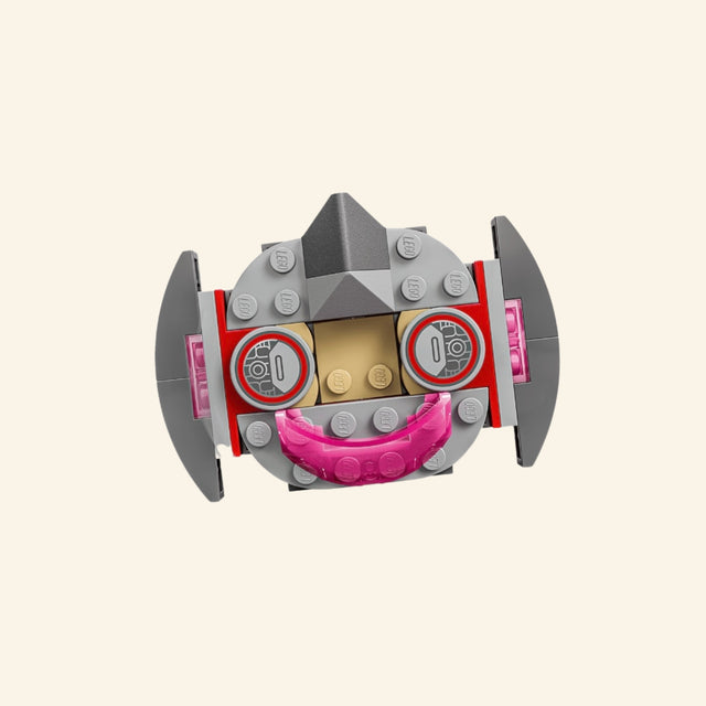 Close-up of Ultron’s small LEGO® flying vehicle from the Ultron vs. Iron Man set, showing gray side pieces, pink front detail, and a seat for the Ultron minifigure.